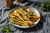 Honey parsnips sitting on a white dinner plate.